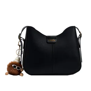 Black minimalist half-moon crossbody bag for women with cute plush sunglasses charm