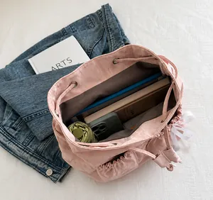 Detail view of pink backpack interior showing spacious capacity for umbrella and books