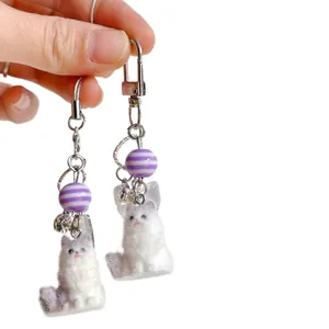 Cute fluffy cat keychain for bags with soft faux fur texture and purple beaded charms
