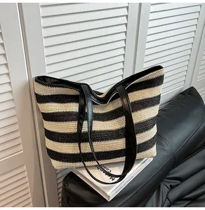 Close-up of the woven texture and black and white stripes of the large tote bag