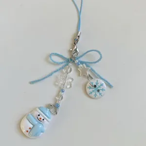 Winter snowman and snowflake beaded phone strap with light blue accents and silver clasp