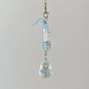 Winter snowman beaded phone charm with snowflake tag and blue knitted accent