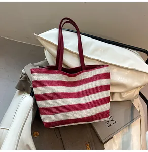 Close-up of red and white striped woven tote bag showing texture and leather handles