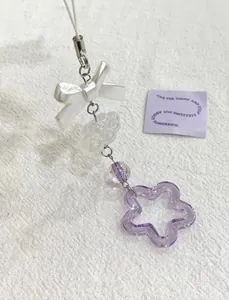 Détail d'un charme fait main avec nœud en résine, perle nuage et pendentif étoile violette