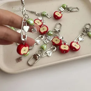 Red apple charm keychain with green heart bead and Good Luck tag for phone and bags