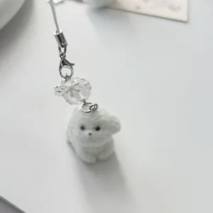 Portachiavi con cucciolo floccato bianco con moschettone argento e perla decorativa