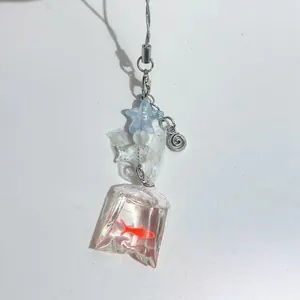 Handmade beaded keychain with goldfish bag charm and blue star bead on a gray cord