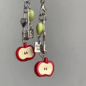 Red apple keychain with Good Luck metal tag and green bead on a silver lobster clasp