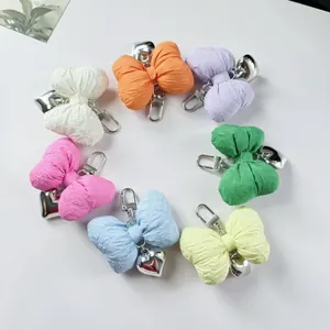 Colorful fabric bow keychains with metal heart pendants in a circular arrangement