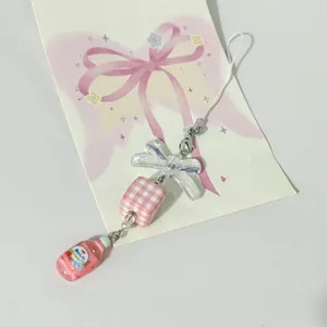 Handgefertigter Perlen-Anhänger mit rosa Fläschchen und Aurora-Schleife für Handys