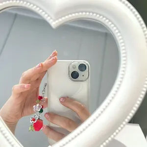 Handmade beaded phone charm featuring 3D strawberry, pink heart and clear flower beads