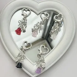 Elegant silver heart-shaped keychain with resin rose and bow charm in five colors