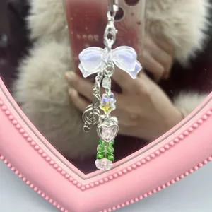Pink beaded phone charm with bow, treble clef pendant and heart shaped beads