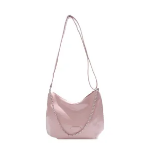 Chic pink glossy leather tote bag with metallic chain and adjustable strap on white background
