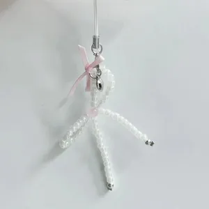 Handmade ballet-style pearl bead bow phone charm with pink ribbon and silver heart pendant