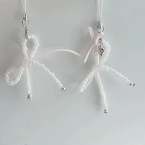 Handmade balletcore beaded phone charms with pearl white beads and pink satin ribbons