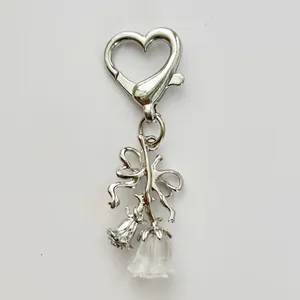Elegant silver bow and lily of the valley floral keychain accessory with heart clasp