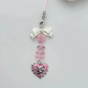 Pink bear handmade beaded phone strap with ribbon bow and heart-shaped pendant charms