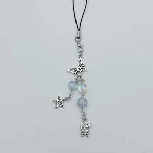 Y2K beaded phone charm with silver stars, butterfly, and skull charms on a black lanyard