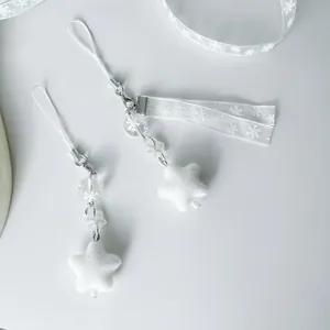 Handmade white plush star charm with snowflake beads and silver ribbon decoration