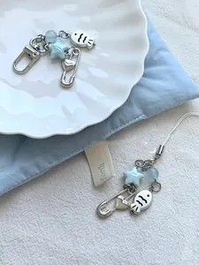 Detail of blue beaded phone charms with silver lobster clasp and minimalist fish motif