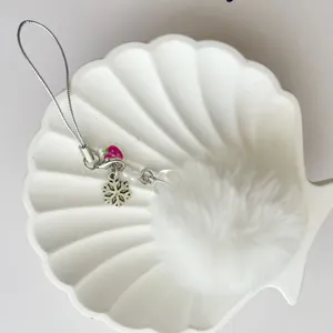 Cute white pompom phone strap with pink strawberry beads and silver snowflake charm