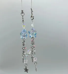 Close-up of holographic acrylic star beads and metal pendants with just for you text