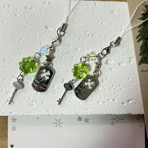 Green lucky clover phone charm with silver key pendant and engraved metal heart tag