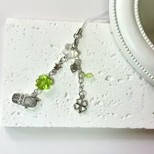 Y2K four-leaf clover phone strap with silver star, heart, and retro TV charms