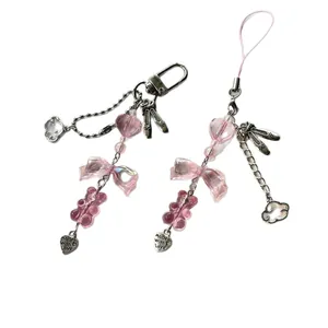 Pink beaded phone charm and keychain with bow, bear charms and metal pendants