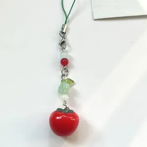 Handmade realistic tomato charm keychain with green beads and leaf detail on white base