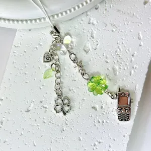 Silver beaded phone strap with green clover, butterfly and mini phone charms
