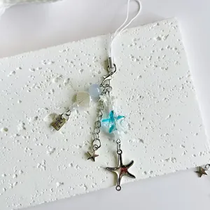 Ocean themed beaded phone strap with sea star charm and Good Luck metal tag