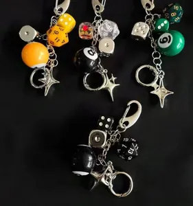 Detailed view of handmade dice and billiard ball keychains with star charms