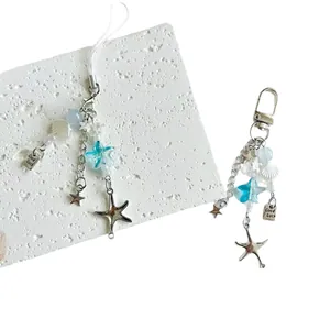 Ocean style beaded keychains with blue stars, sea shell charms and Good Luck metal tag
