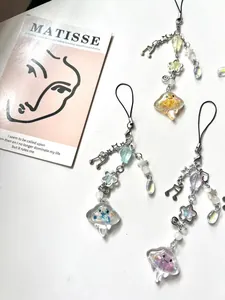 Detail of colorful resin jellyfish charms with glitter, stars, and beads on metal chains