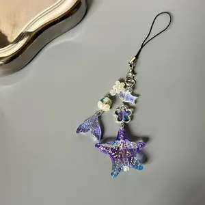 Blue mermaid tail and star beaded phone strap with glitter resin ocean charms