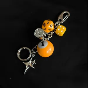 Handmade dice bag charm with yellow D20, billiards ball and silver star pendants