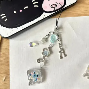 Handmade ocean jellyfish phone charm with beaded heart and star pendants on a phone case