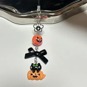 Detail of Halloween lanyard with black cat pumpkin charm and orange bead accessory