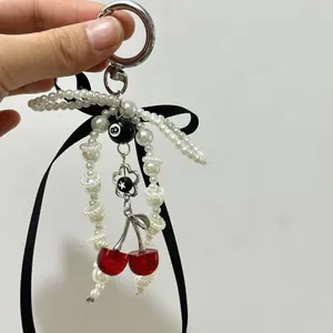 Elegant beaded pearl keychain with black ribbon bow and billiard ball cherry charms