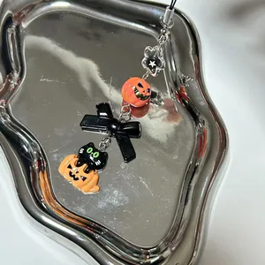 Halloween phone lanyard with black cat on pumpkin charm and black acrylic bow