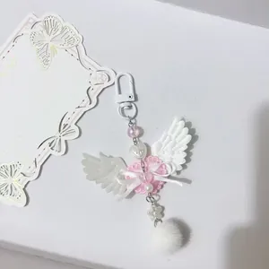 Sweet pink angel wing keychain with lace heart, ribbon bow and white faux fur ball