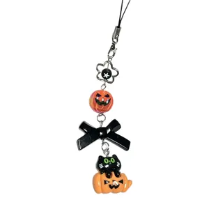 Halloween phone charm strap with black cat in pumpkin figure and orange bead decoration