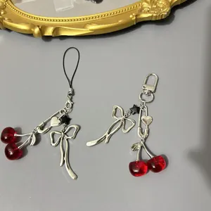 Sweet cherry bow phone strap and bag charm with resin beads and metallic pin details