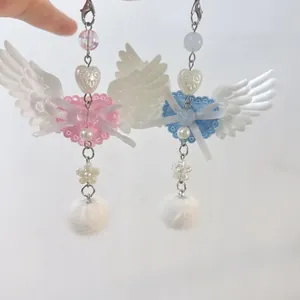 Pink and blue angel wing heart charms with plush pompoms and ribbon for bags or phones