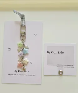 Close-up of pastel resin stars and metal star pendants on a handmade phone charm