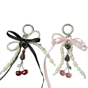 Handmade pearl keychain with silk bow and resin cherry charms in pink and black colors