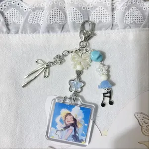 Acrylic photo frame keychain with blue and white charms and silver metal accessories