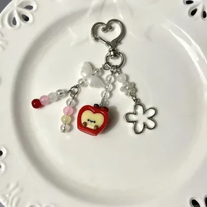Creative beaded keychain featuring red apple pendant and heart shaped metal clasp